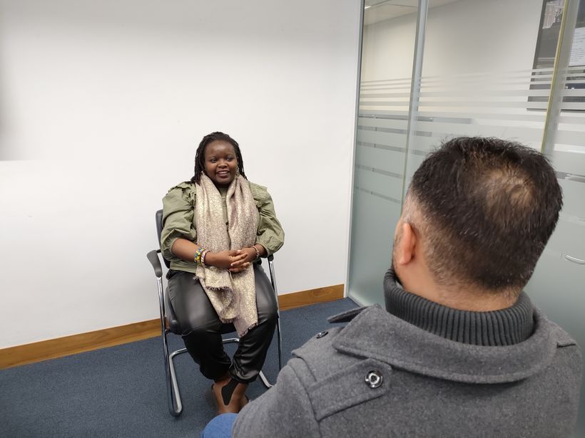 A woman talking to a man in a meeting room