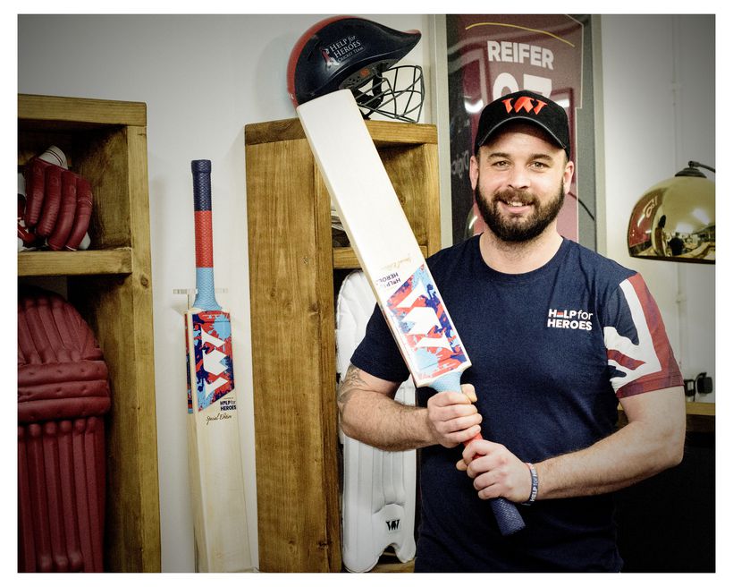 Veteran holding handmade cricket bat