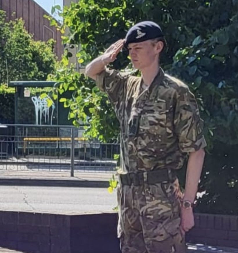 Zak Light in cadet uniform saluting outdoors