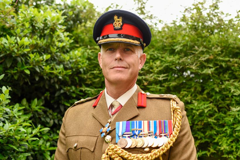 A photo of a man in ceremonial Army uniform.