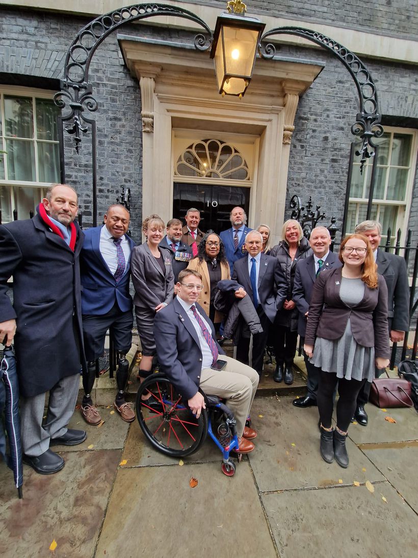 Ten veterans standing outside of the 10 Downing Street Door