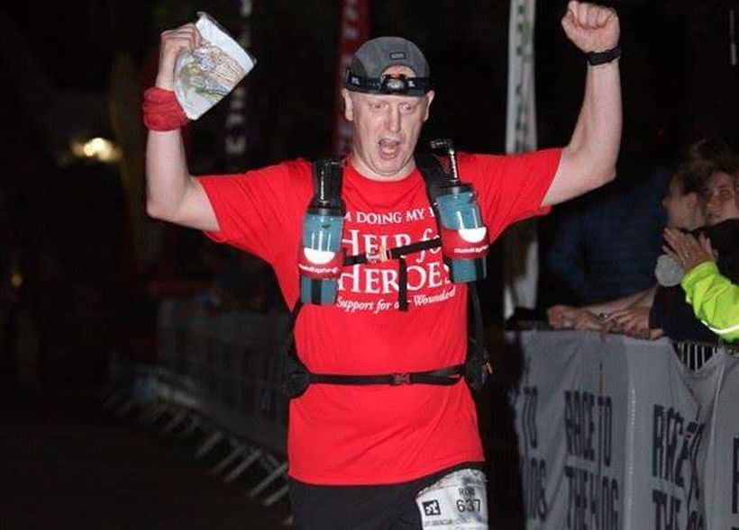 Rob cheers at the finishing line after running a marathon