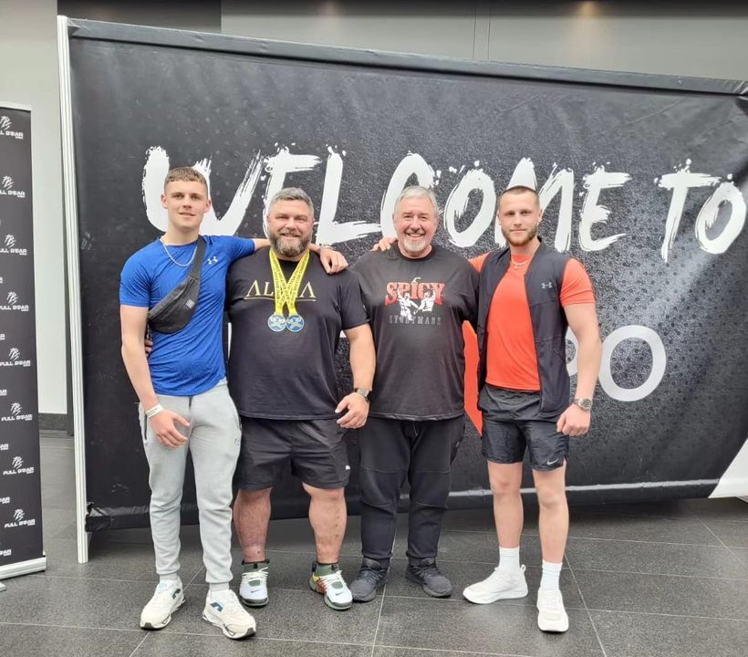 Darren, his two sons and own father standing celebrating his win