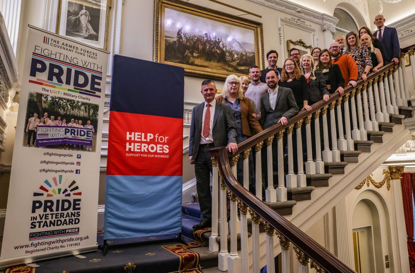 Armed Forces and LGBT+ stakeholders standing on staircase
