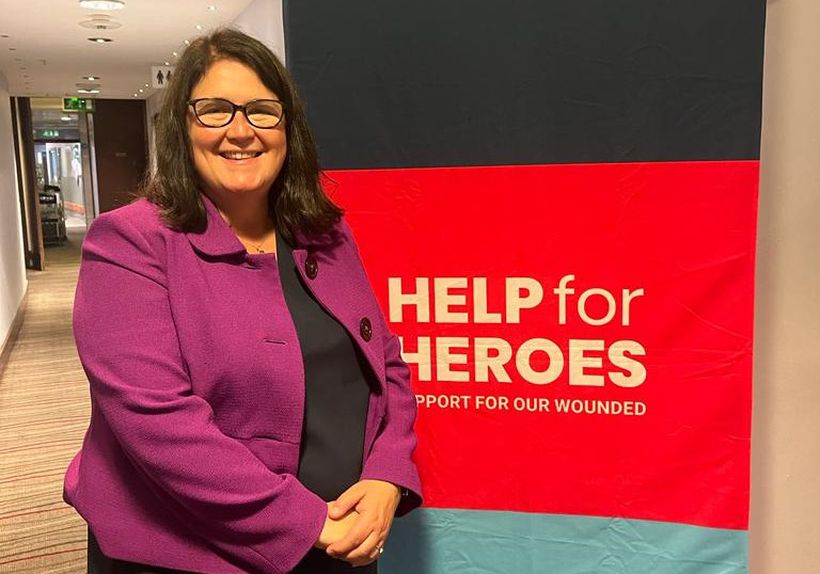 Rachel Hopkins MP in purple jacket with Help for Heroes banner
